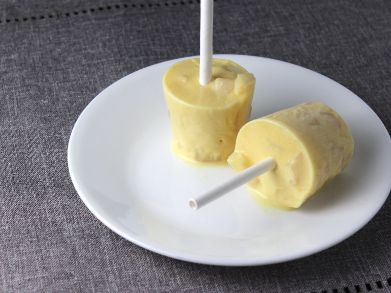 2 frozen pear pops on a white plate