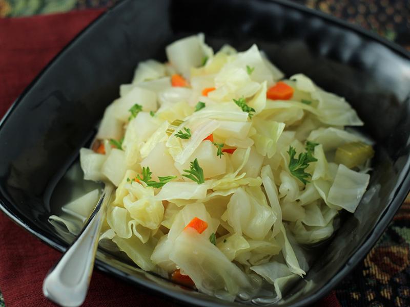 Cabbage and Ham Bone Soup in a black bowl