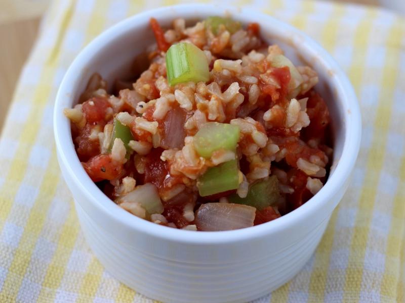 serving of Cheesy Rice and Tomatoes in a white dish