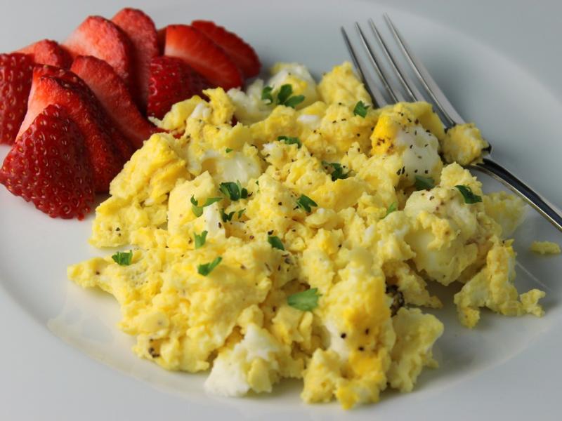 Eggsactly right eggs recipe served on a white plate with strawberries