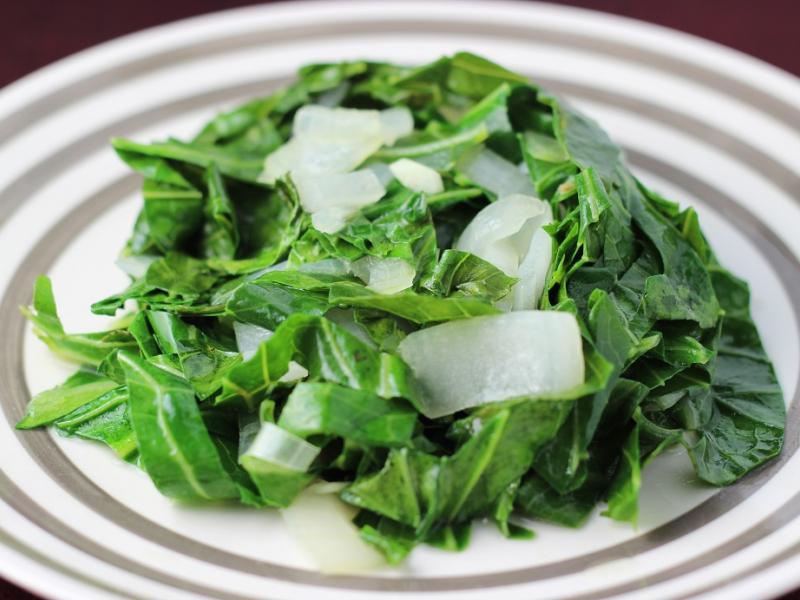 cooked collard greens on a striped plate