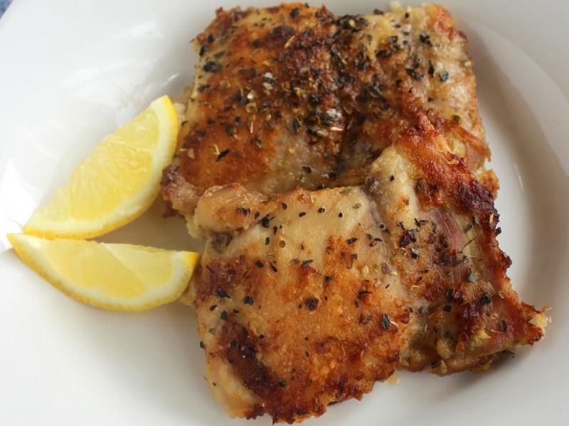 oven fried chicken with lemon wedge garnish