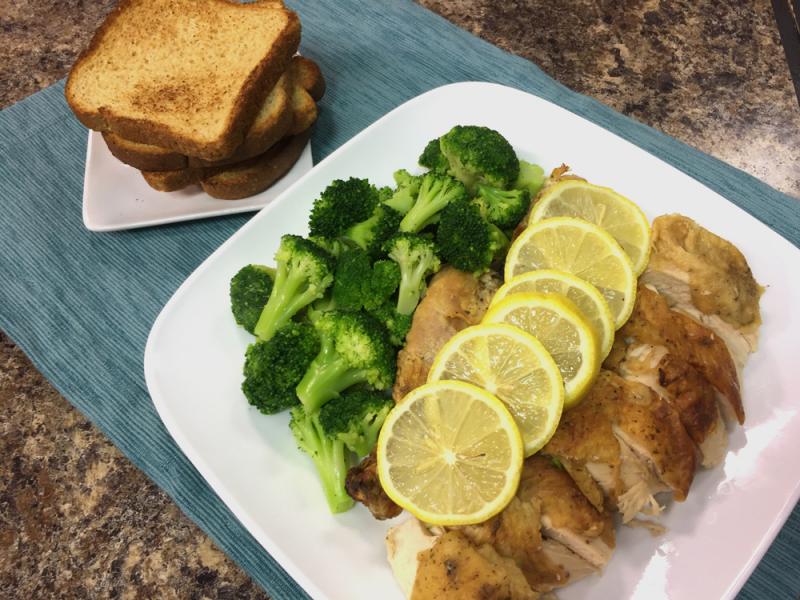 Roasted Chicken and broccoli on a white plate with a side of wheat toast