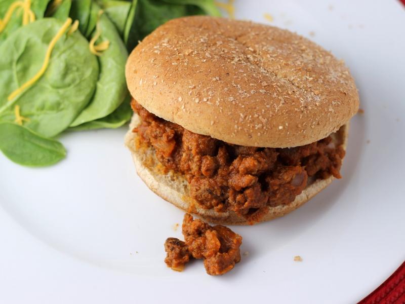 Sweet Pumpkin Sandwich on a whole wheat bun served with side of spinach salad