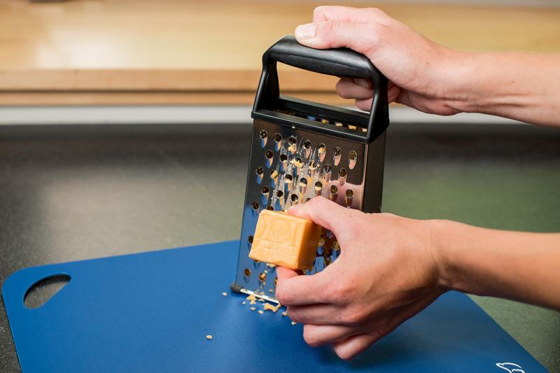 grating cheese with a box grater