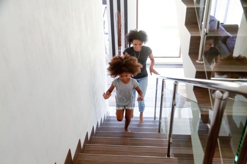 mom and daughter going up the stairs