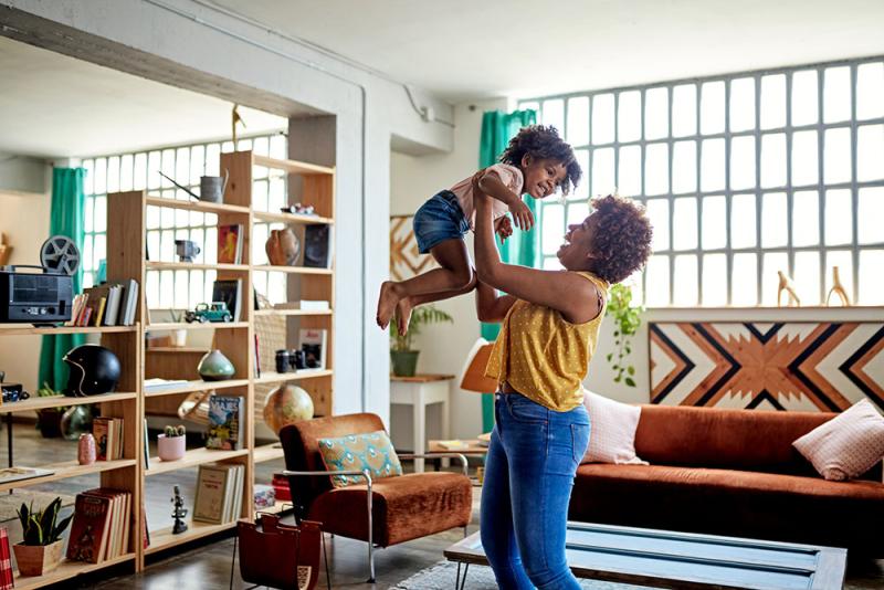 mom picking up child high in the air